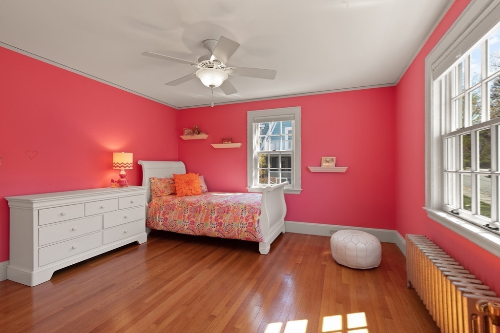 2 Plymouth Road Lexington, MA 02421 - Photo 22 of 38 a bedroom with a bed and a chandelier