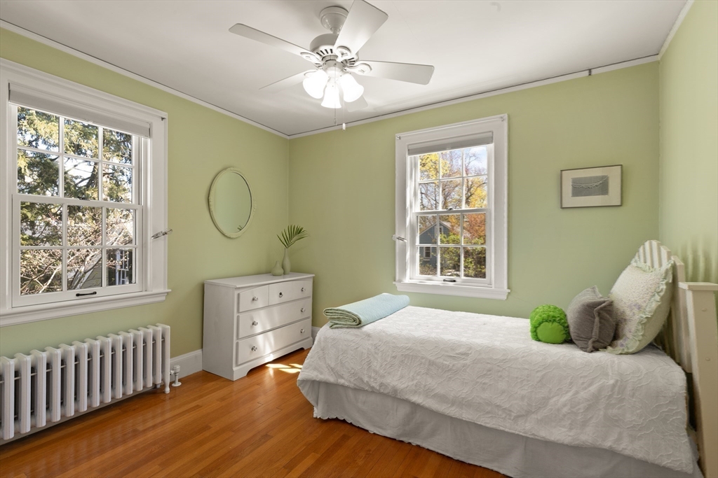 2 Plymouth Road Lexington, MA 02421 - Photo 23 of 38 a bedroom with a large bed and wooden floor
