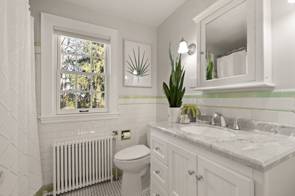 2 Plymouth Road Lexington, MA 02421 - Photo 24 of 38 a bathroom with a granite countertop sink a toilet and a window