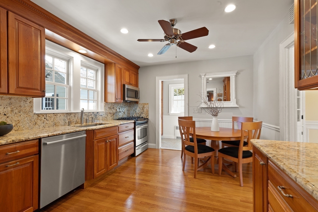 2 Plymouth Road Lexington, MA 02421 - Photo 8 of 38 a kitchen with granite countertop a table chairs sink and cabinets