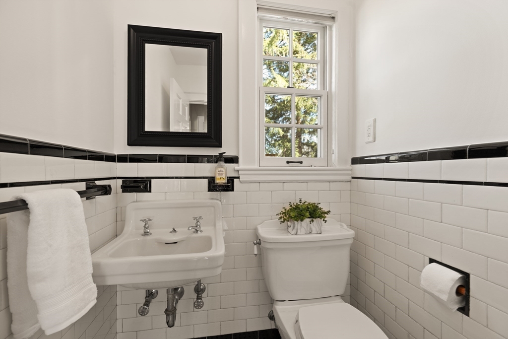 2 Plymouth Road Lexington, MA 02421 - Photo 10 of 38 a bathroom with a sink a toilet and mirror