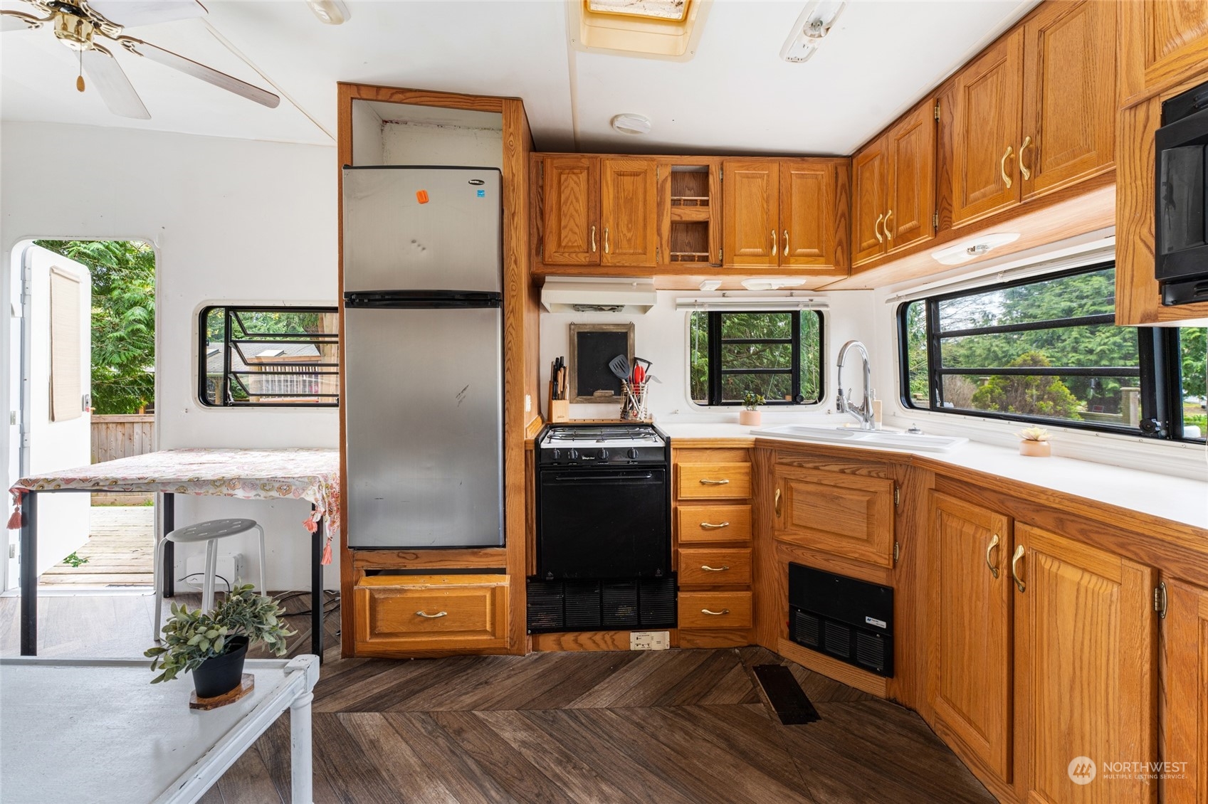 4542 Decatur Drive Ferndale, WA 98248 - Photo 22 of 24 a kitchen with stainless steel appliances granite countertop a refrigerator a stove a sink dishwasher and wooden cabinets with wooden floor