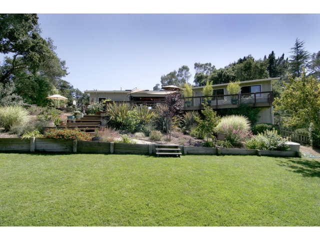 455 Poppy Hill Road Watsonville, CA 95076 - Photo 1 of 25 a view of a house with a garden and a swimming pool