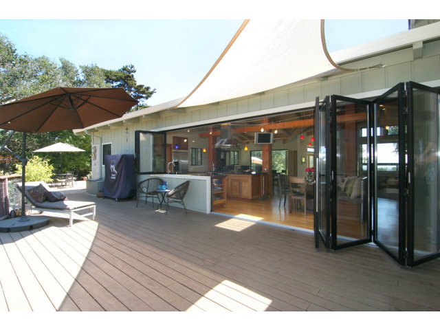 455 Poppy Hill Road Watsonville, CA 95076 - Photo 11 of 25 a outdoor view of a patio with a table and chairs under an umbrella