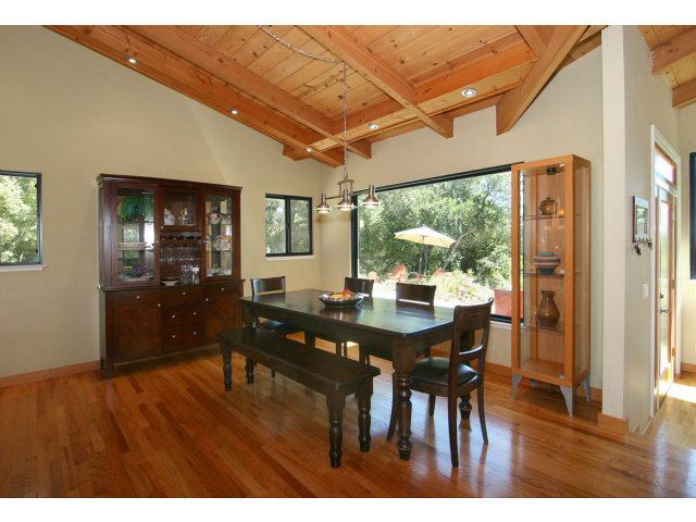 455 Poppy Hill Road Watsonville, CA 95076 - Photo 8 of 25 a dining room with furniture large windows and wooden floor