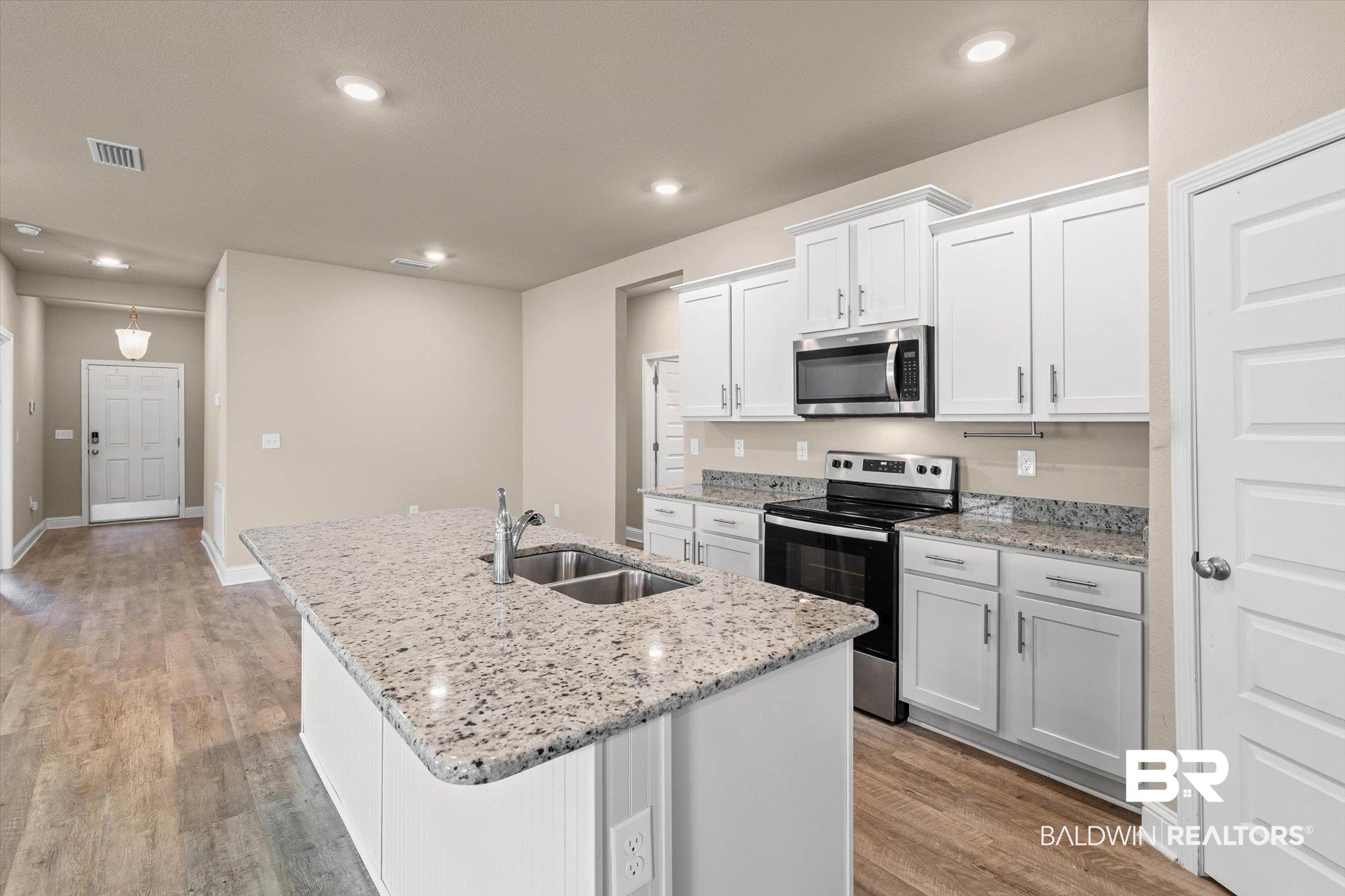 22976 Lieutenant Avenue Foley, AL 36535 - Photo 8 of 30 Kitchen with stainless steel appliances, white cabinets, an island with sink, light wood finished floors, and recessed lighting