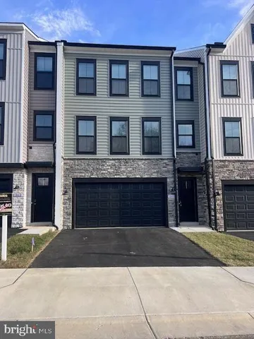 a front view of a brick house with a yard