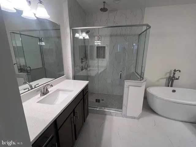 a bathroom with a sink a toilet a mirror and shower