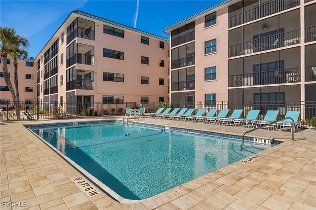 a view of a swimming pool with a lounge chair