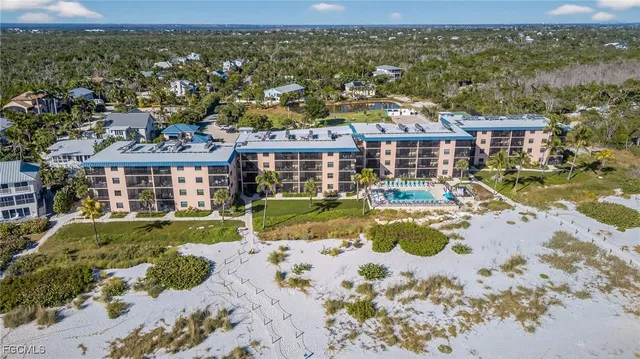 a view of a house with a big yard and large trees