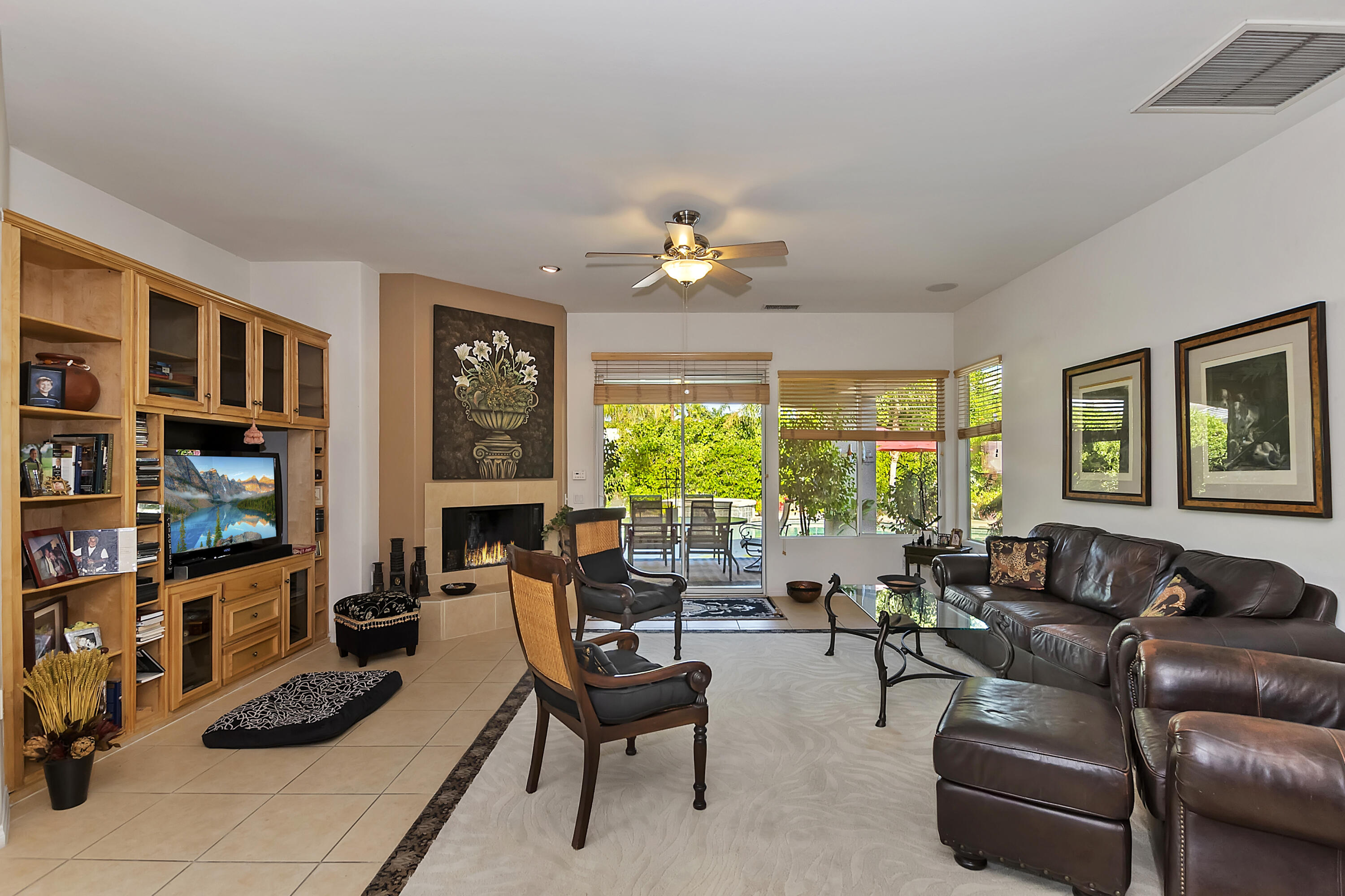 60 Victor Hugo Road Rancho Mirage, CA 92270 - Photo 15 of 44 a living room with furniture a fireplace and a large window
