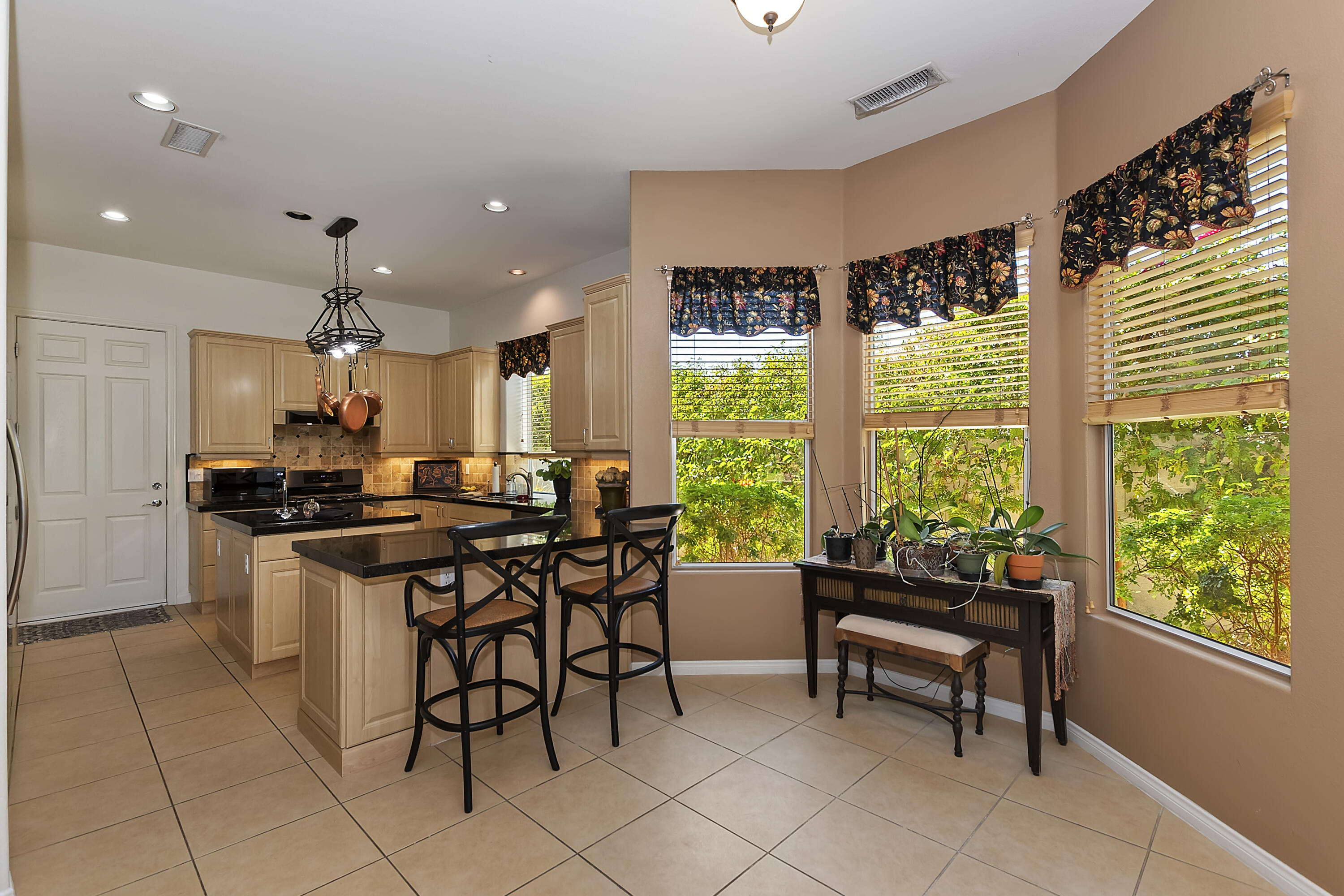 60 Victor Hugo Road Rancho Mirage, CA 92270 - Photo 18 of 44 a kitchen with kitchen island a large window in it