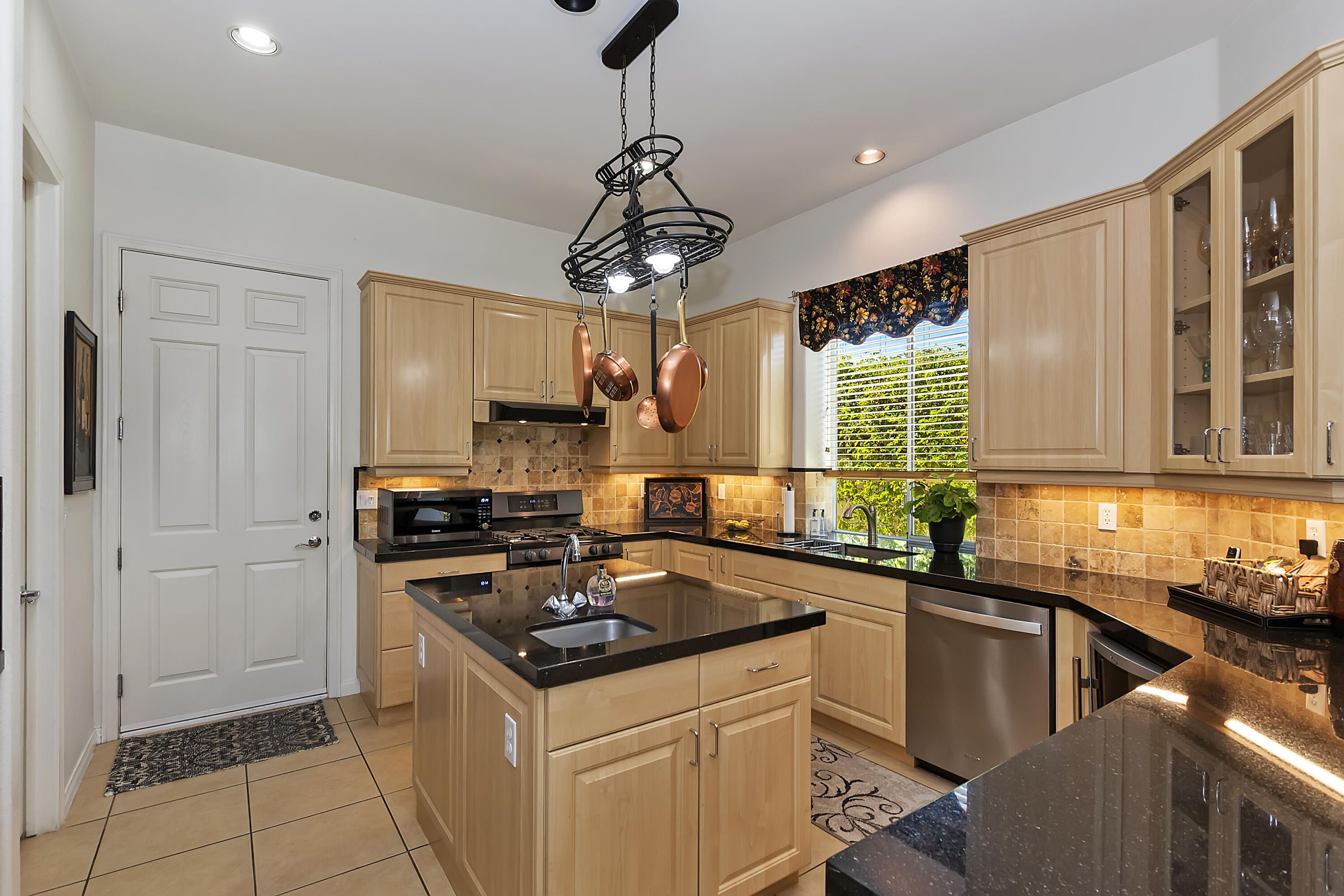 60 Victor Hugo Road Rancho Mirage, CA 92270 - Photo 19 of 44 a kitchen with stainless steel appliances a sink stove and refrigerator