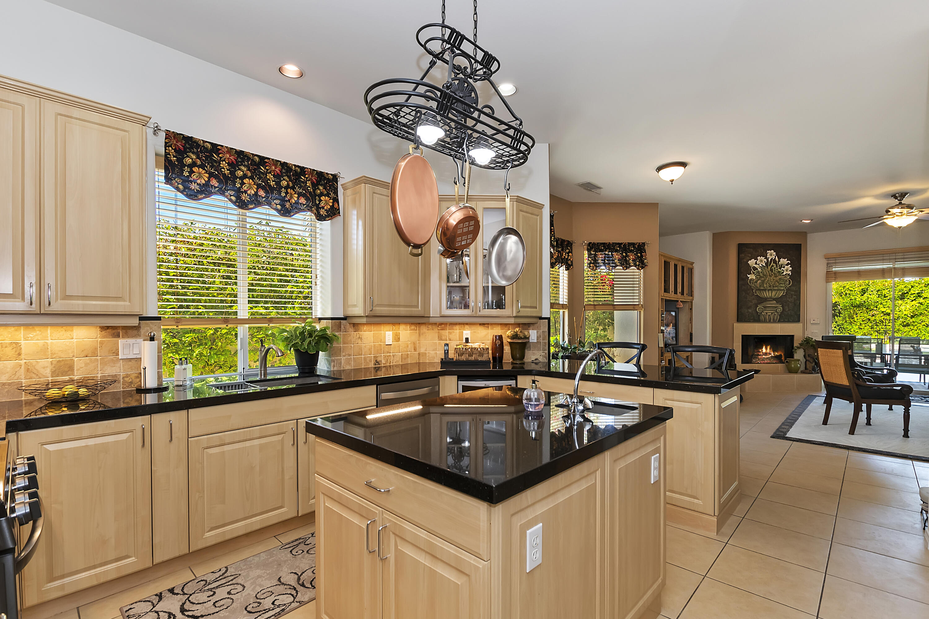 60 Victor Hugo Road Rancho Mirage, CA 92270 - Photo 22 of 44 a kitchen with granite countertop a sink and cabinets