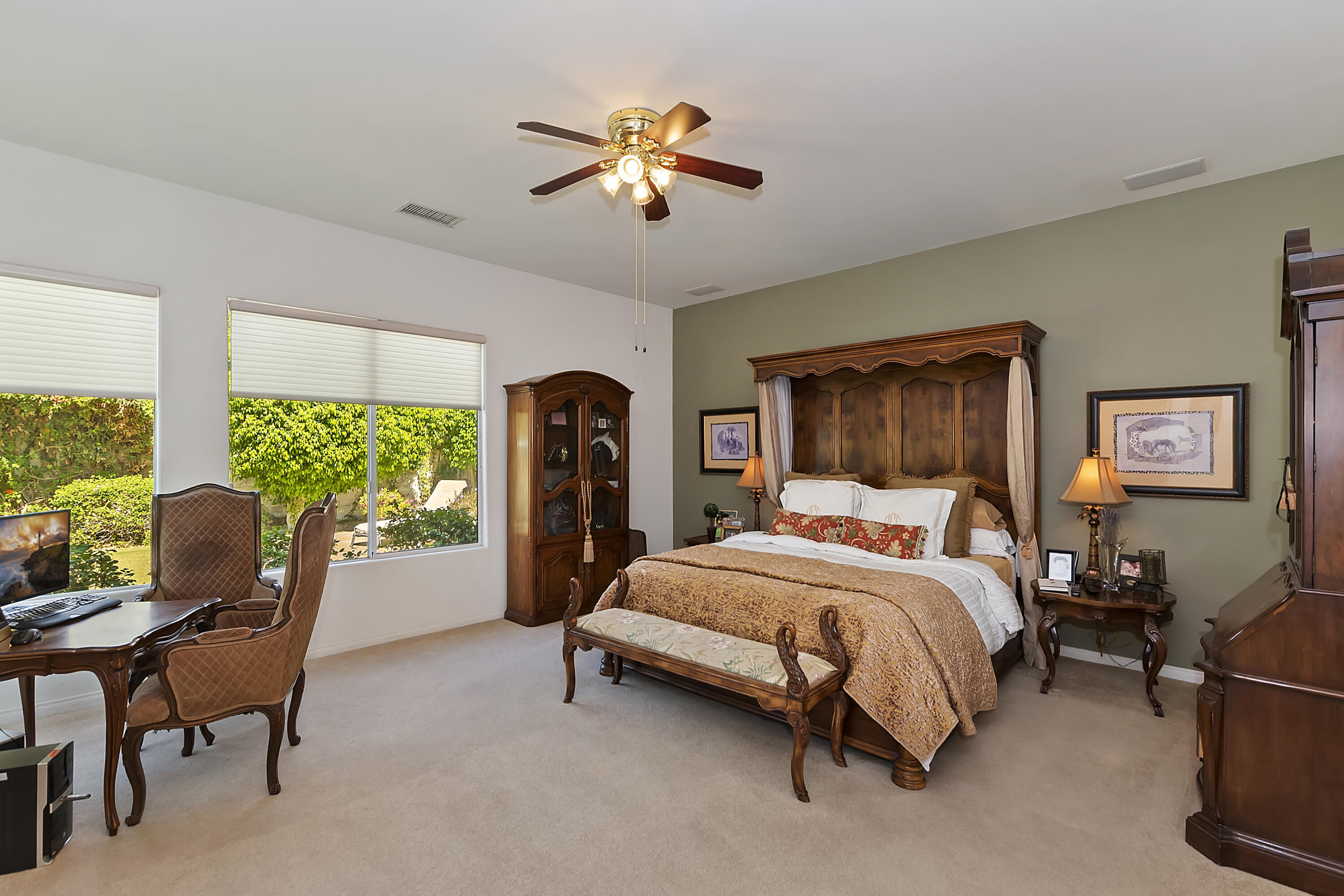 60 Victor Hugo Road Rancho Mirage, CA 92270 - Photo 24 of 44 a bedroom with a bed and a chandelier