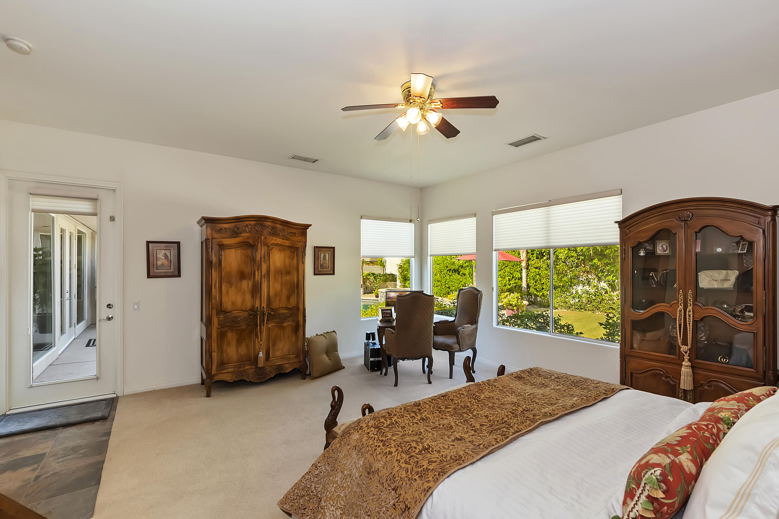 60 Victor Hugo Road Rancho Mirage, CA 92270 - Photo 25 of 44 a bedroom with a bed and a chandelier