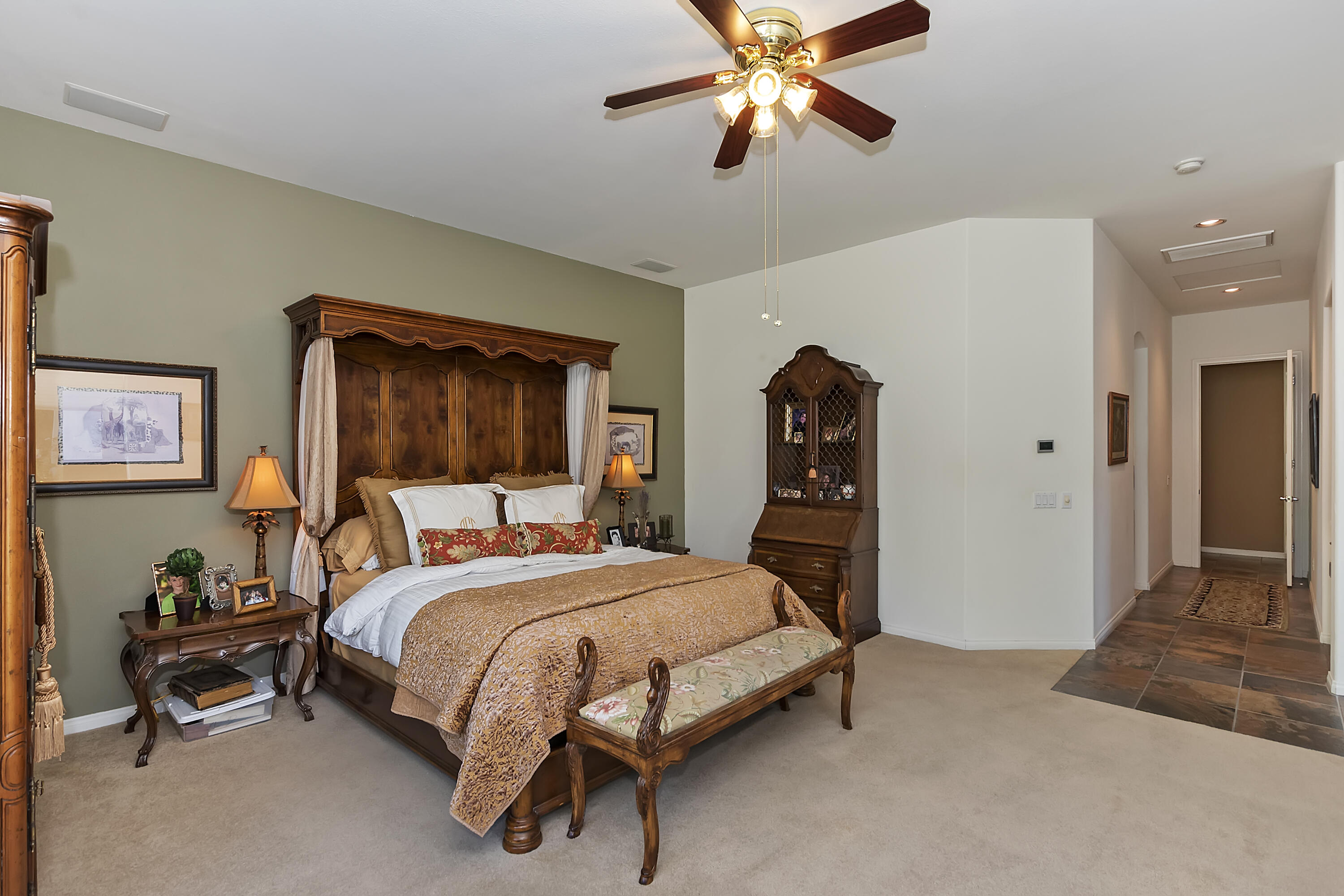 60 Victor Hugo Road Rancho Mirage, CA 92270 - Photo 27 of 44 a bedroom with a bed and a chandelier