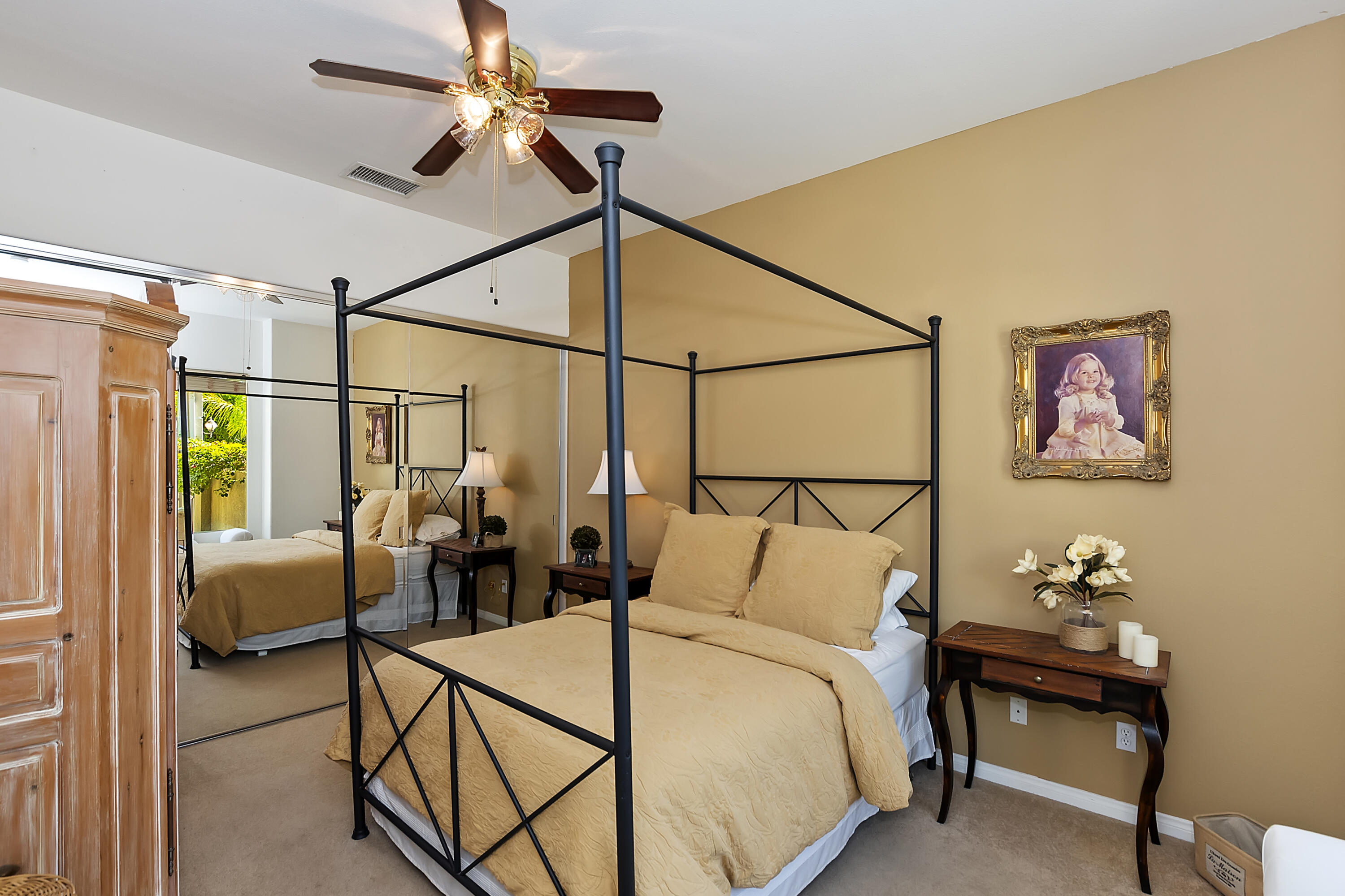 60 Victor Hugo Road Rancho Mirage, CA 92270 - Photo 30 of 44 a bedroom with a bed a couch and paintings on the wall
