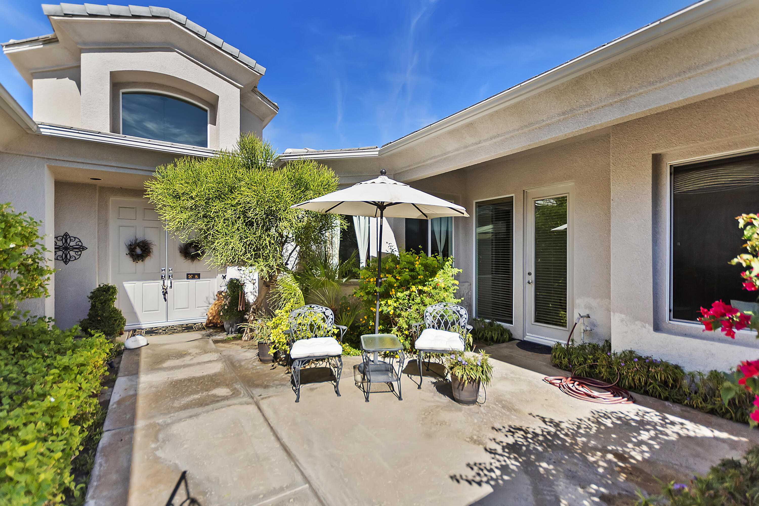 60 Victor Hugo Road Rancho Mirage, CA 92270 - Photo 3 of 44 a view of a patio with plants and chairs