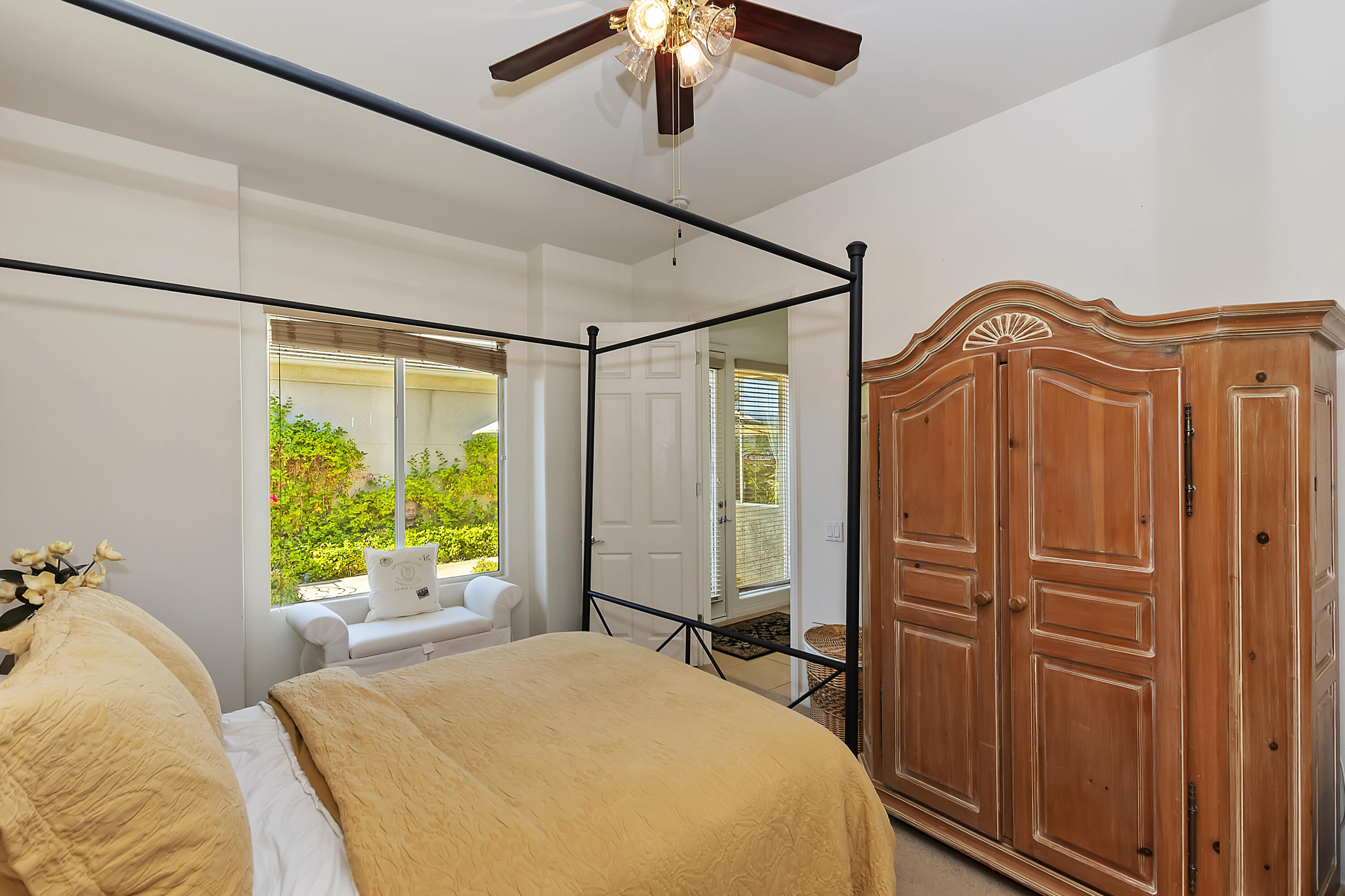 60 Victor Hugo Road Rancho Mirage, CA 92270 - Photo 31 of 44 a bedroom with a bed and a chandelier