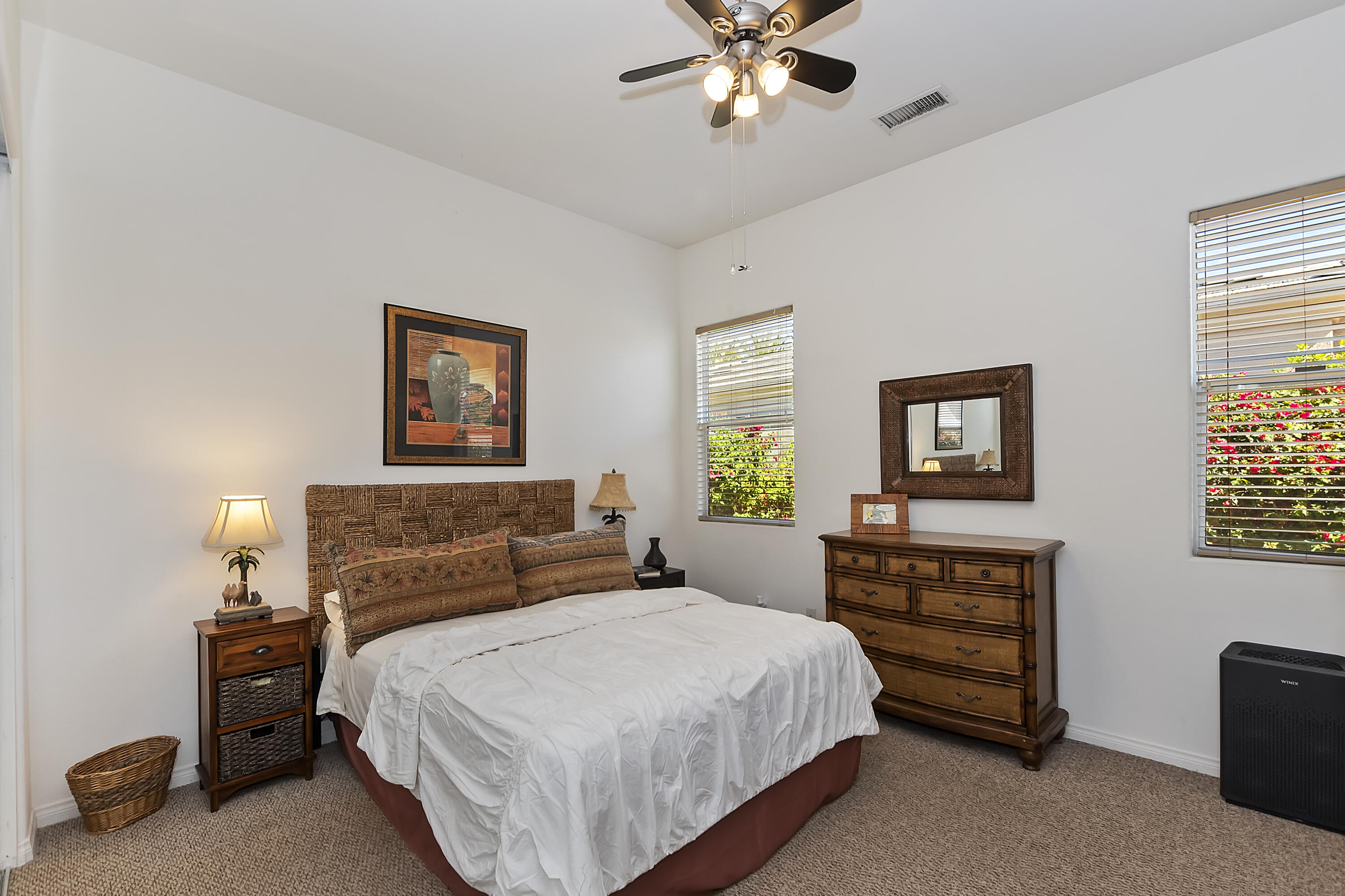 60 Victor Hugo Road Rancho Mirage, CA 92270 - Photo 33 of 44 a bedroom with a bed and a chandelier