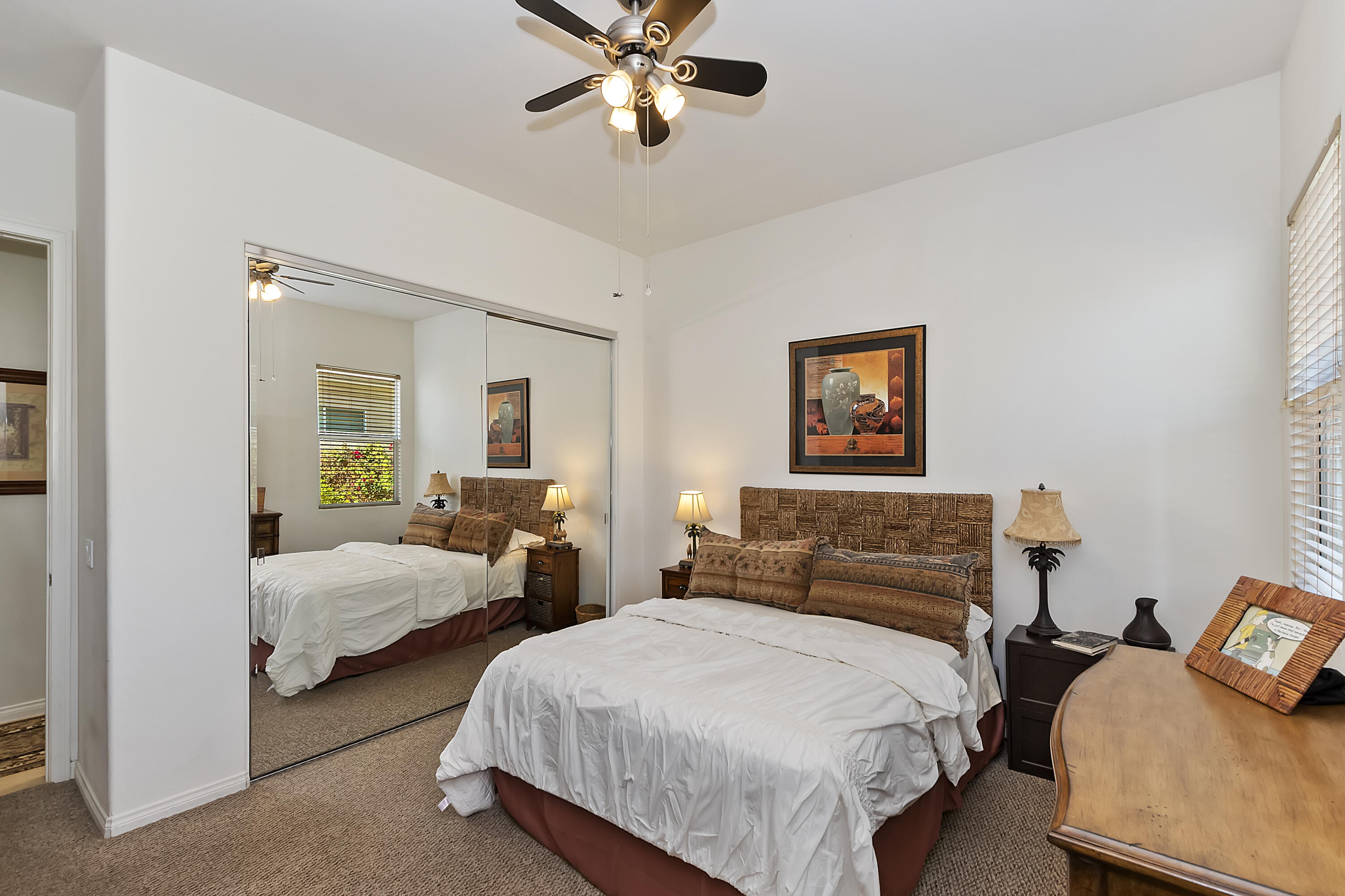 60 Victor Hugo Road Rancho Mirage, CA 92270 - Photo 34 of 44 a bedroom with two beds and a chandelier