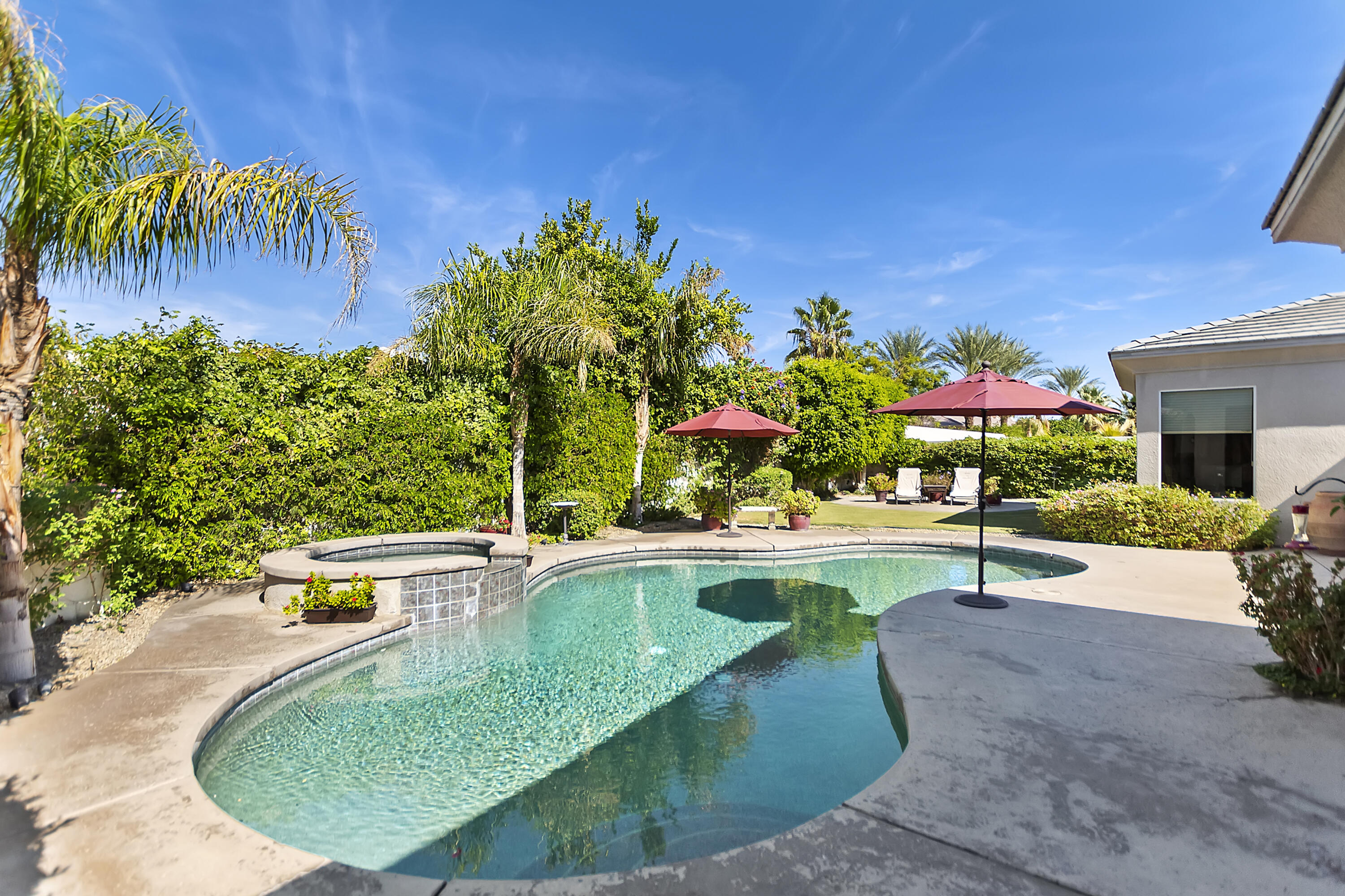 60 Victor Hugo Road Rancho Mirage, CA 92270 - Photo 37 of 44 a view of a swimming pool with a garden