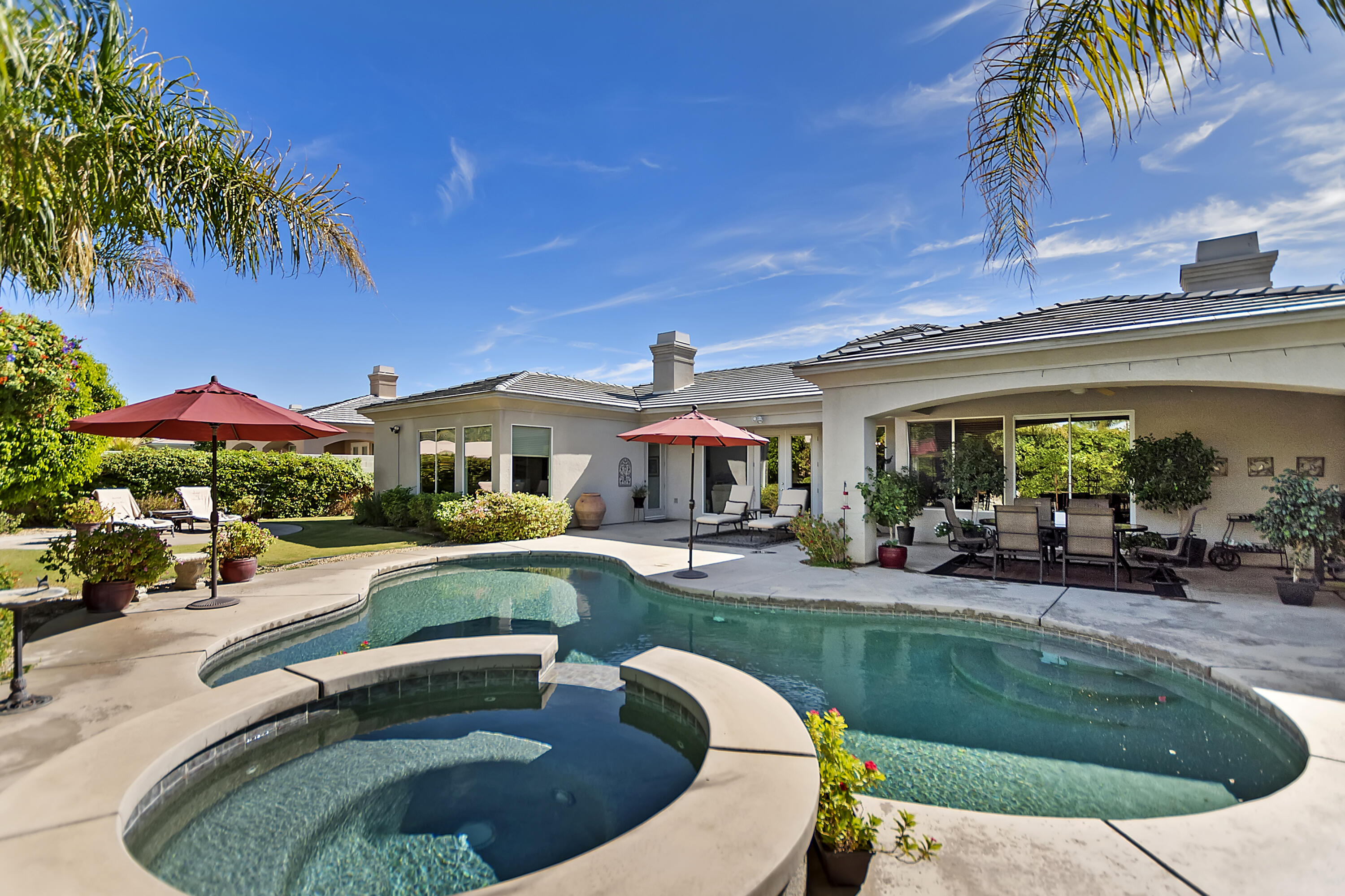 60 Victor Hugo Road Rancho Mirage, CA 92270 - Photo 38 of 44 a view of a house with backyard swimming pool and sitting area