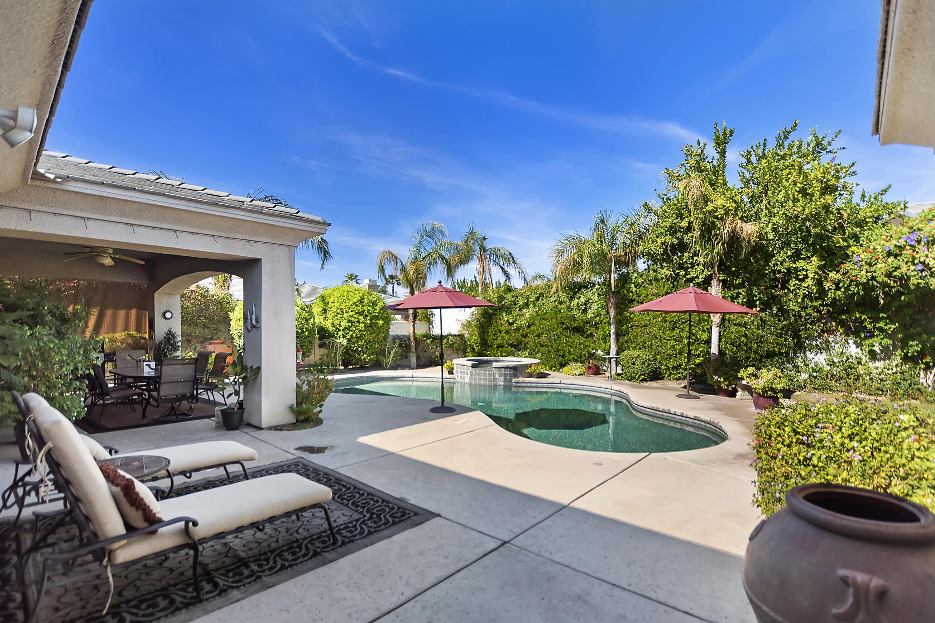60 Victor Hugo Road Rancho Mirage, CA 92270 - Photo 40 of 44 a view of a patio with couches table and chairs and potted plants