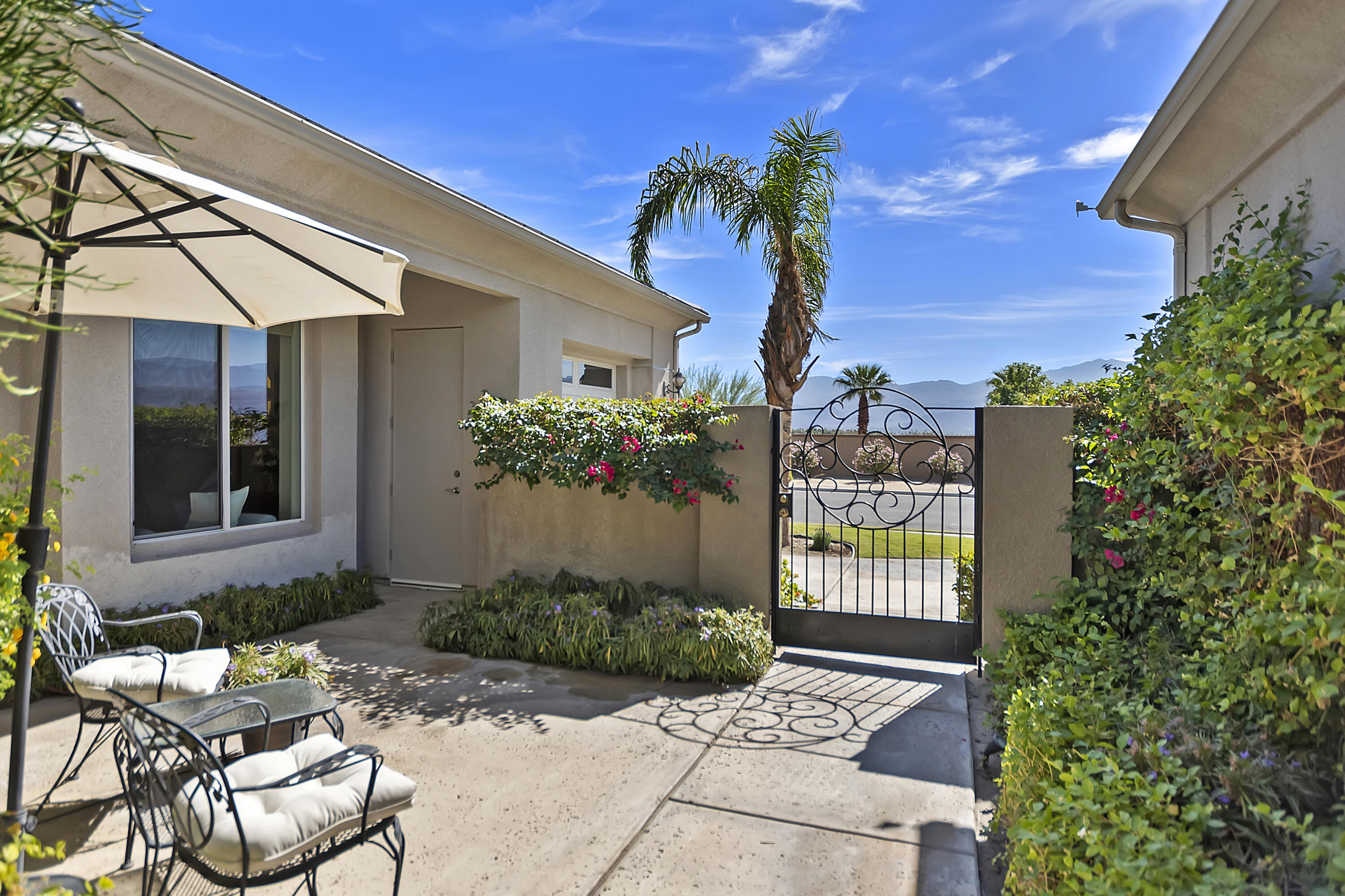 60 Victor Hugo Road Rancho Mirage, CA 92270 - Photo 4 of 44 a potted plant sitting in front of a house