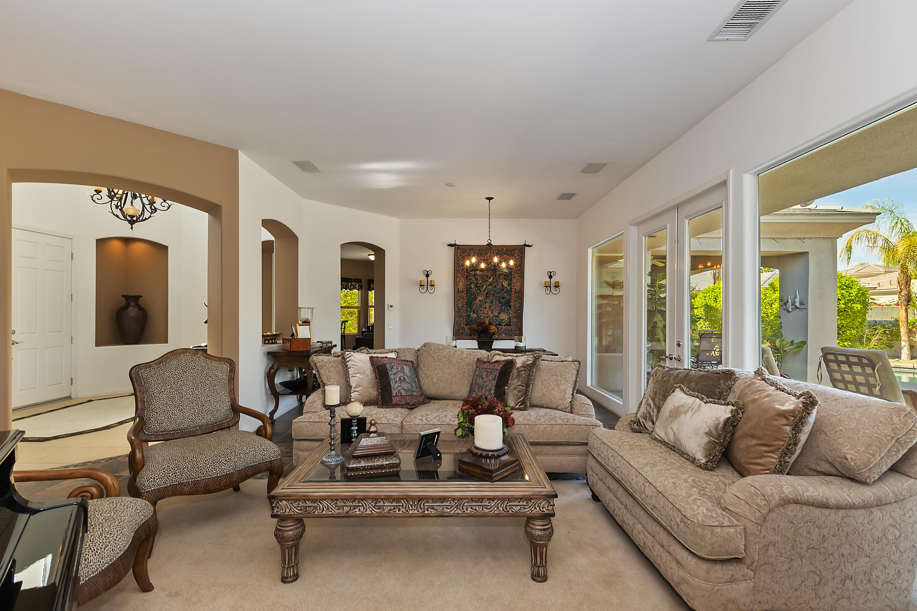 60 Victor Hugo Road Rancho Mirage, CA 92270 - Photo 10 of 44 a living room with furniture ceiling fan and a large window