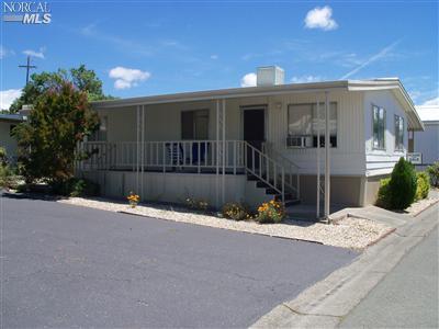 63 Plymouth Way, Unit 63 Santa Rosa, CA 95403 - Photo 1 of 1 This photo shows the covered porch side of the mobile. Note that the mobile sits on the corner of the court so no neighbor is on that side. Nice privacy for the porch and home.