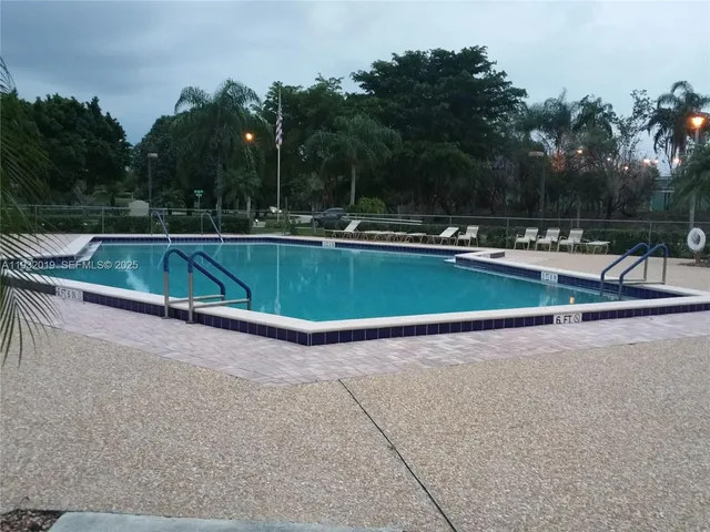 a view of a swimming pool with a yard