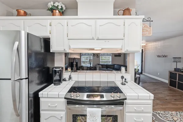 a stove top oven sitting inside of a kitchen