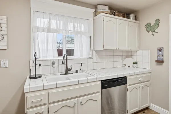 a kitchen with a sink cabinets and window