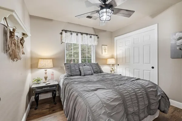 a bedroom with a bed and a chandelier