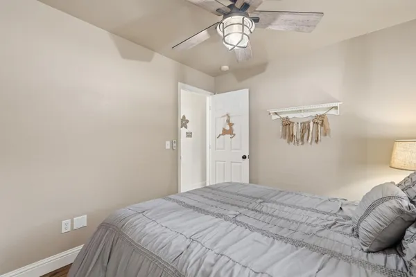 a bedroom with a large bed and a chandelier