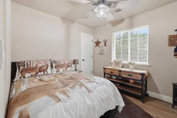 a bedroom with a bed and a chandelier