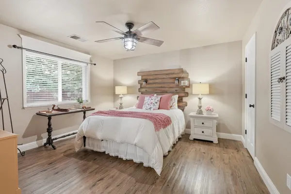 a bedroom with a bed and a chandelier