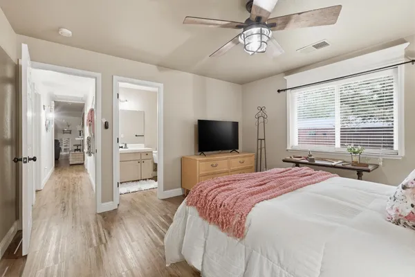 a bedroom with a bed and a flat screen tv