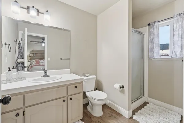 a bathroom with a sink toilet and shower