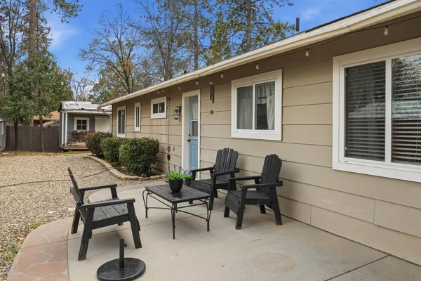 a view of a patio with table and chairs and potted plants