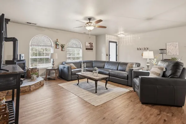 a living room with furniture fireplace and a large window