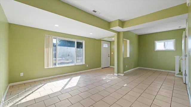 a view of a hallway with a livingroom and a bathroom