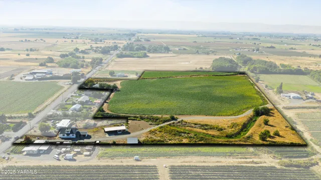 an aerial view of a house with a backyard