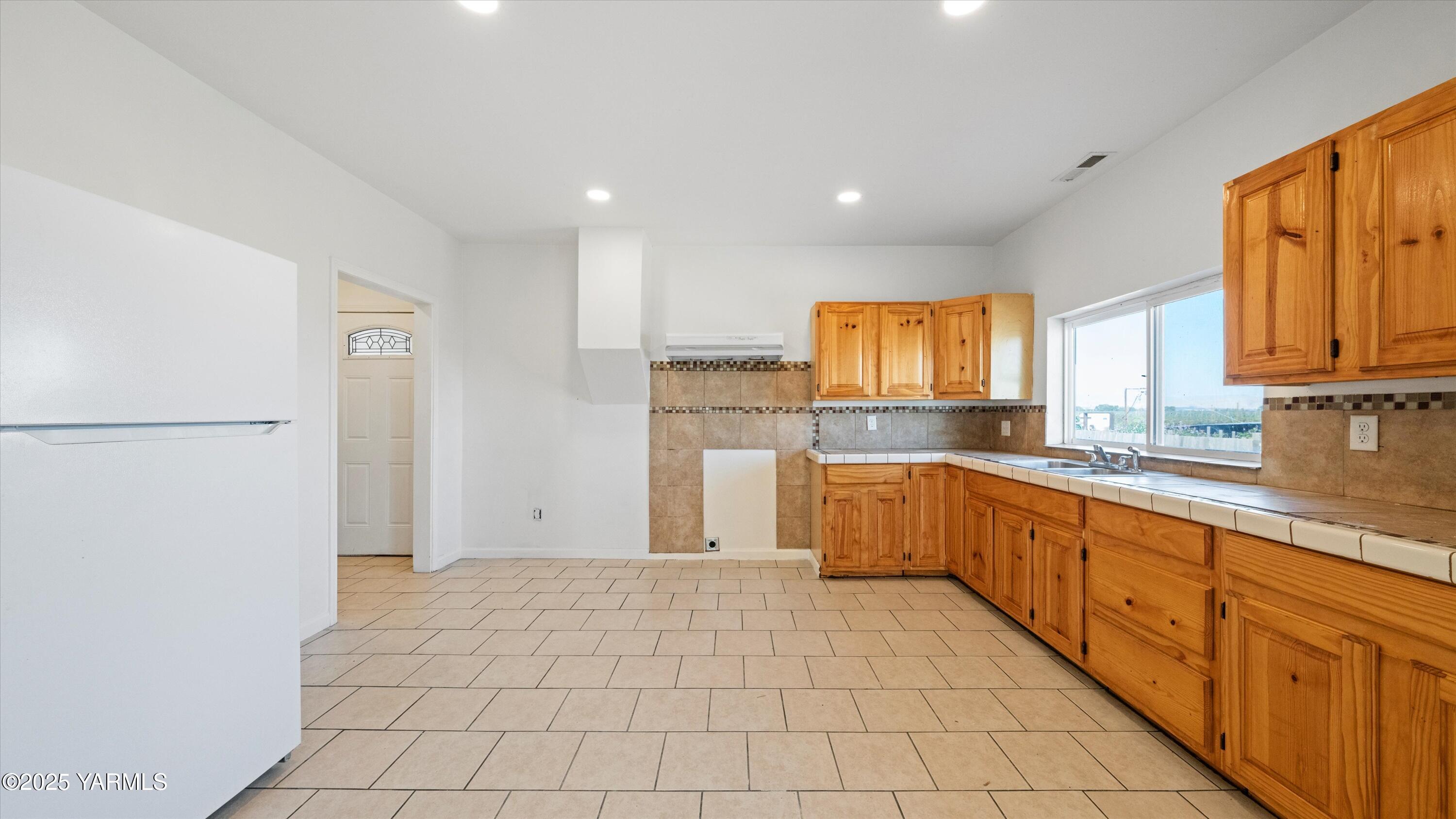 1423 Progressive Road Wapato, WA 98951 - Photo 7 of 24 a large kitchen with stainless steel appliances granite countertop a refrigerator and a stove top oven