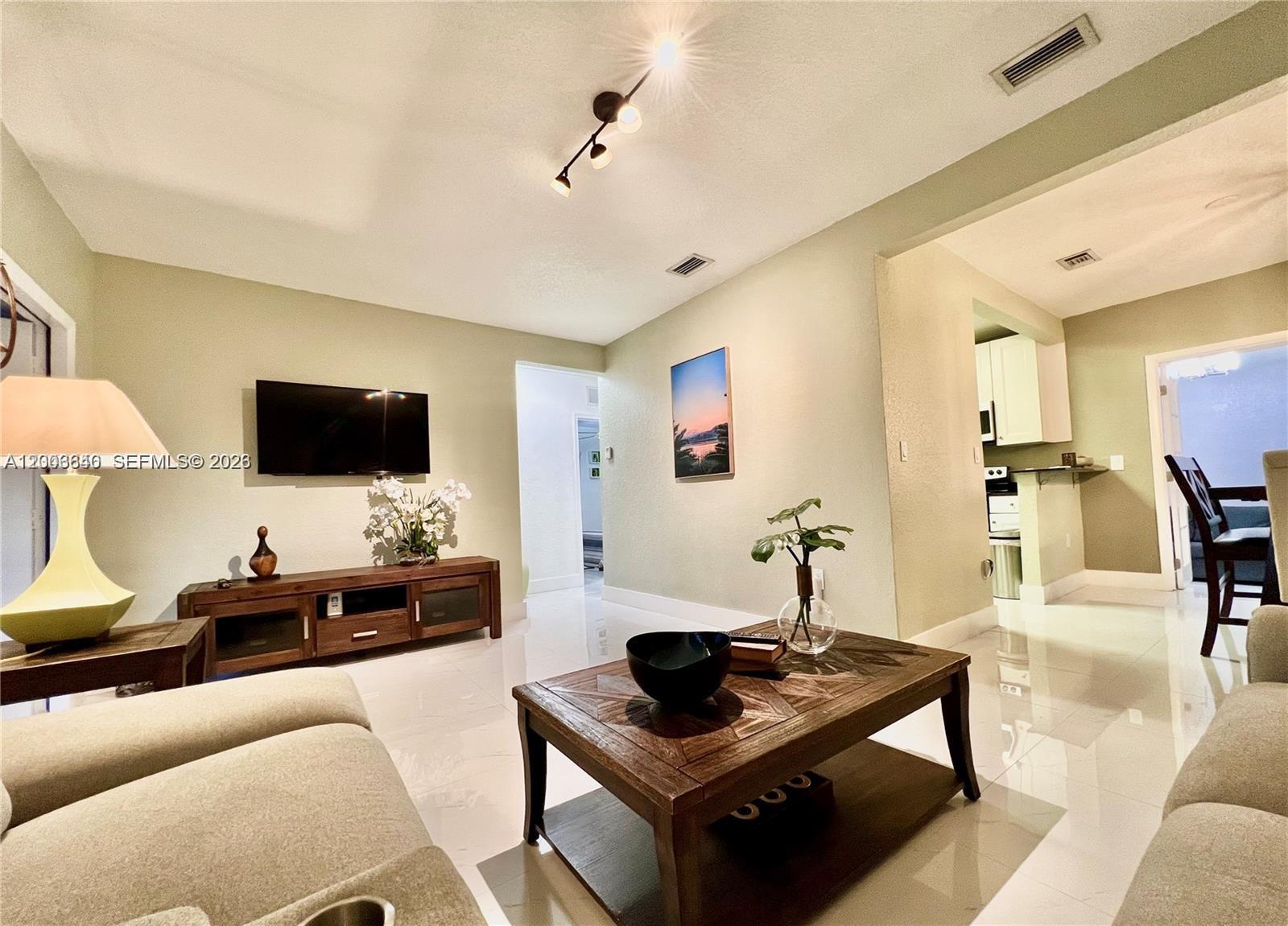 a living room with furniture and a flat screen tv