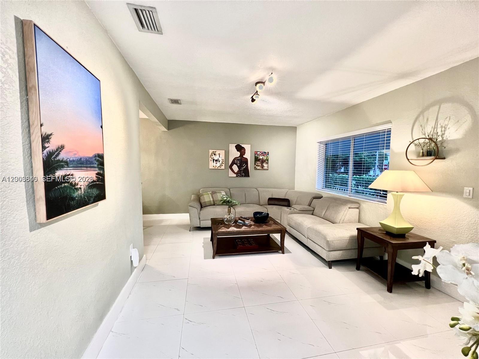 1380 Southwest 11th Street, Unit 1 Miami, FL 33135 - Photo 2 of 20 a living room with furniture and a flat screen tv