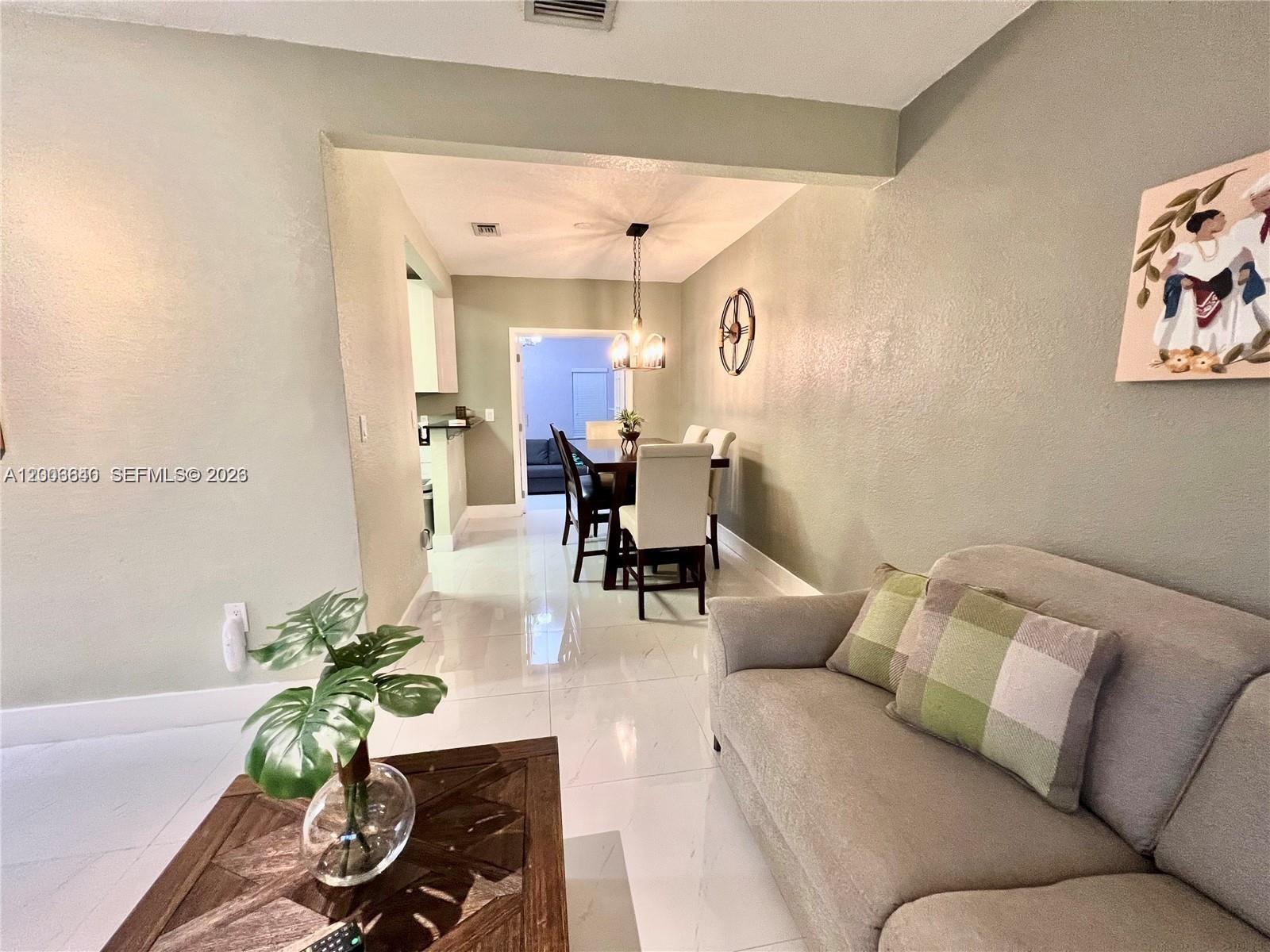 1380 Southwest 11th Street, Unit 1 Miami, FL 33135 - Photo 3 of 20 a living room with furniture flowerpot and wooden floor