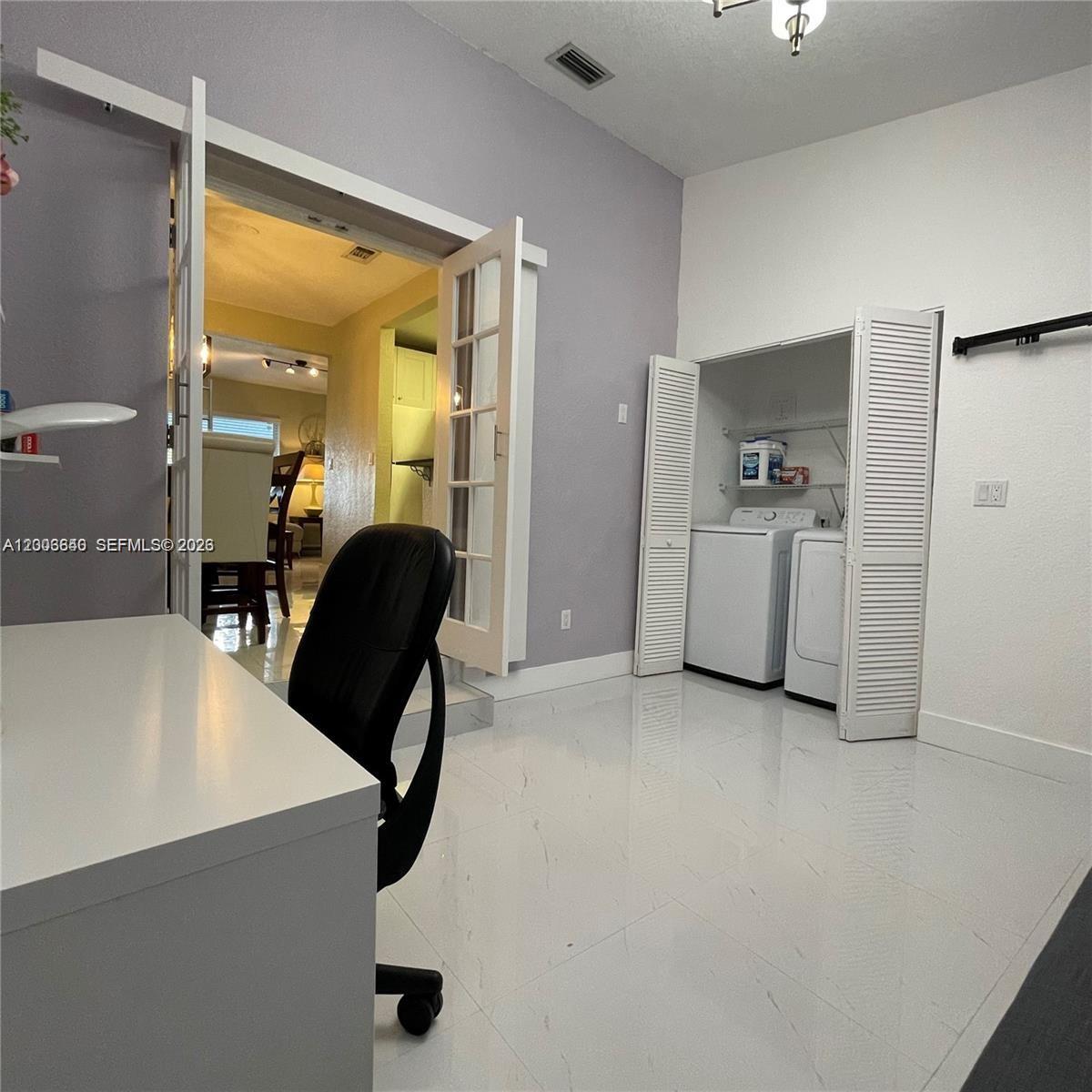 1380 Southwest 11th Street, Unit 1 Miami, FL 33135 - Photo 7 of 20 a living room with furniture and a refrigerator